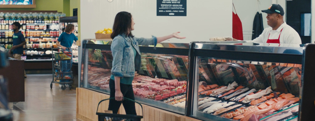 customer ordering at meat counter